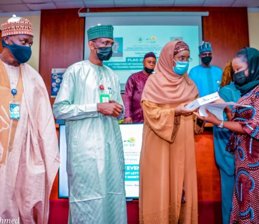 (3rd Left) The Honourable Minster of Humanitarian Affairs, Disaster Management and Social Development, Sadiya Umar Farouq, (2nd Left) the Permanent Secretary of the Ministry, Bashir Nura Alkali, (1st Left) National Coordinator for NSIP, Engr. Umar B. Bindir, (1st Right) an Independent Monitor, Aisha H. Ihiabe, during the Flag - Off, of the distribution of engagement letters and monitoring devices to Independent Monitors, on 10th June, 2021, in Abuja. Photo: Khalid Ahmed.