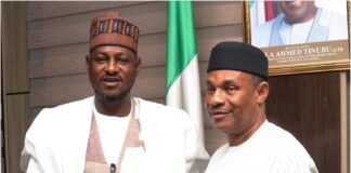Executive Governor of Katsina state in a handshake with the Permanent Secretary of Ministry of Aviation and Aerospace